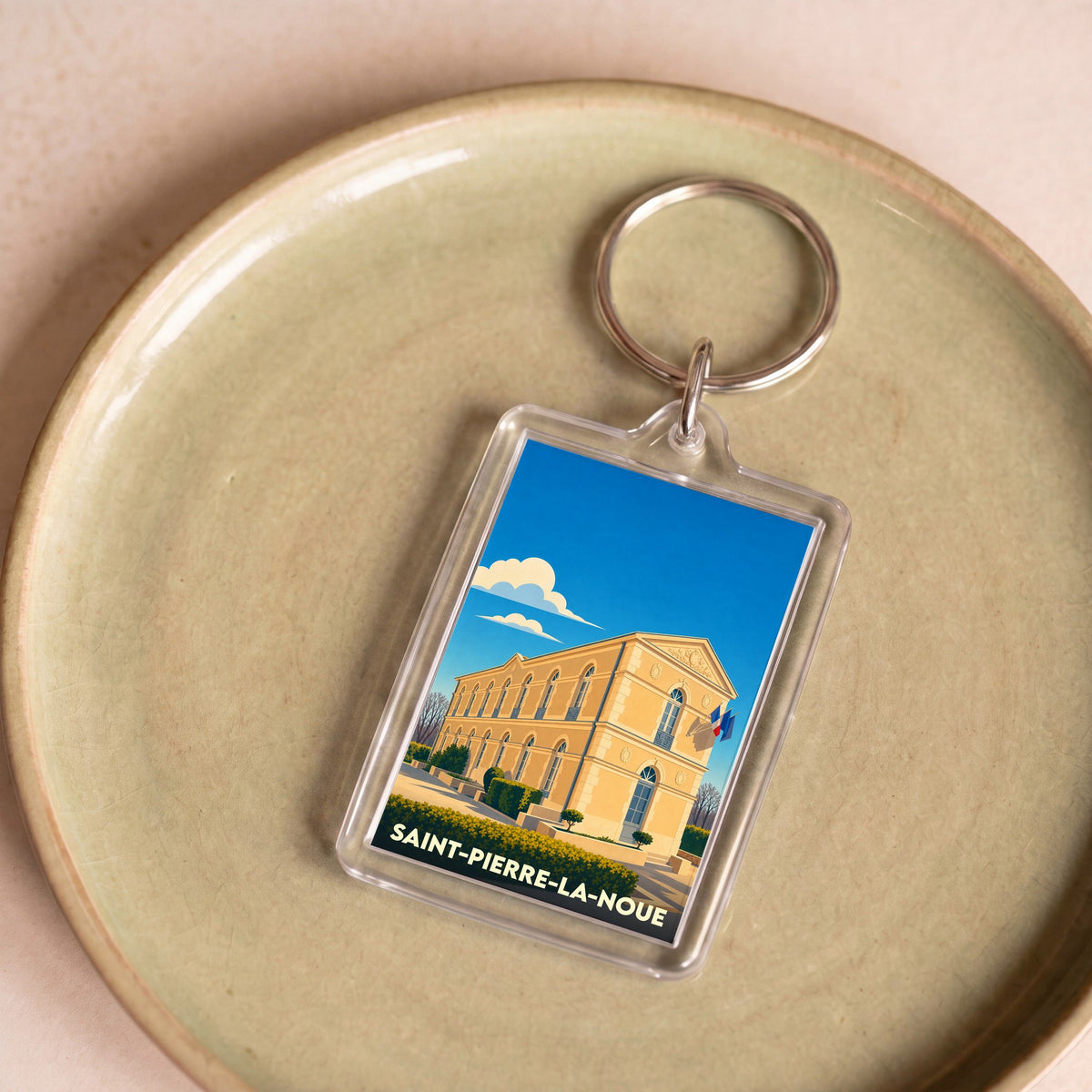 Porte-clés souvenir de la ville de Saint-Pierre-La-Noue avec une illustration stylisée.