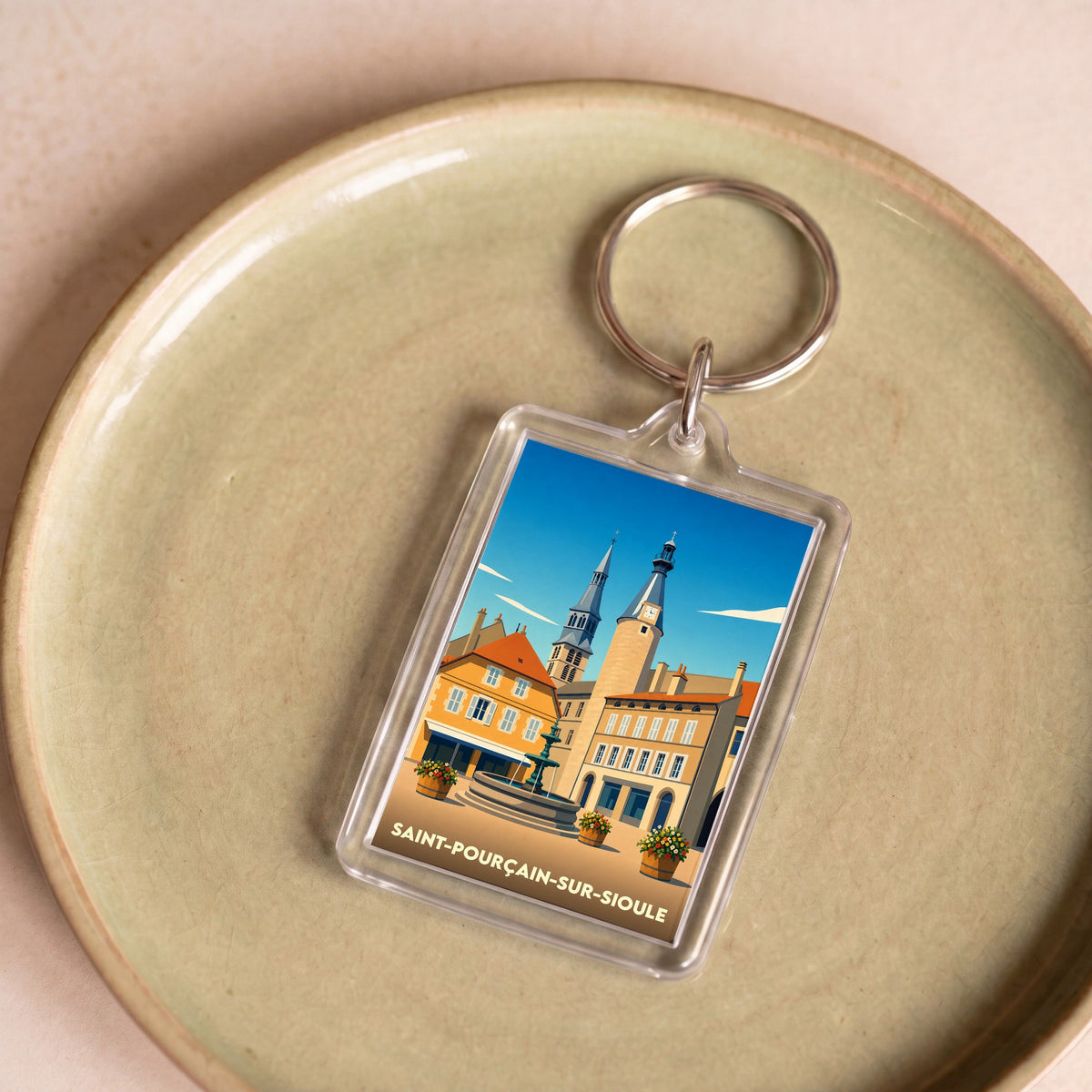 Porte-clés souvenir de la ville de Saint-Pourçain-sur-Sioule avec une illustration stylisée.