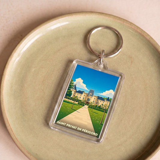 Porte-clés souvenir de la ville de Saint Privat en Périgord avec une illustration stylisée.
