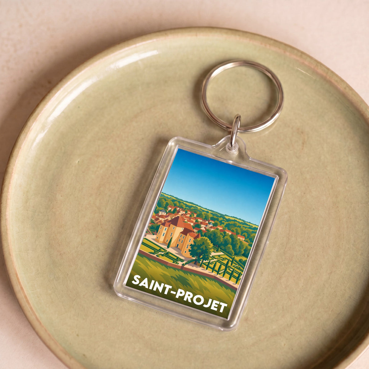 Porte-clés souvenir de la ville de Saint-Projet avec une illustration stylisée.