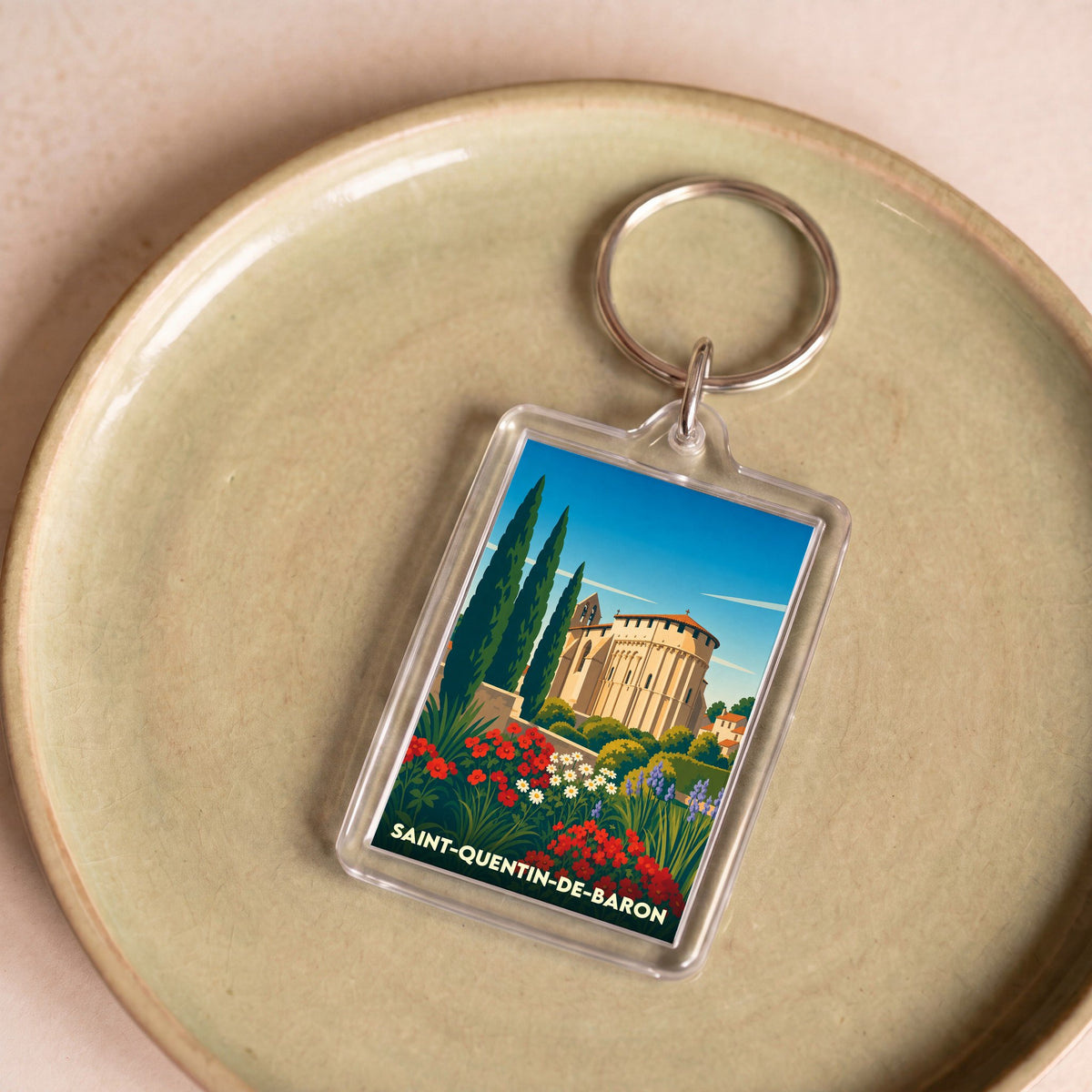 Porte-clés souvenir de la ville de Saint-Quentin-de-Baron avec une illustration stylisée.