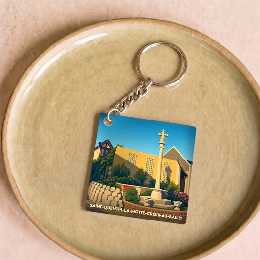 Porte-clés souvenir de la ville de Saint-Quentin-la-Motte-Croix-au-Bailly avec une illustration stylisée.