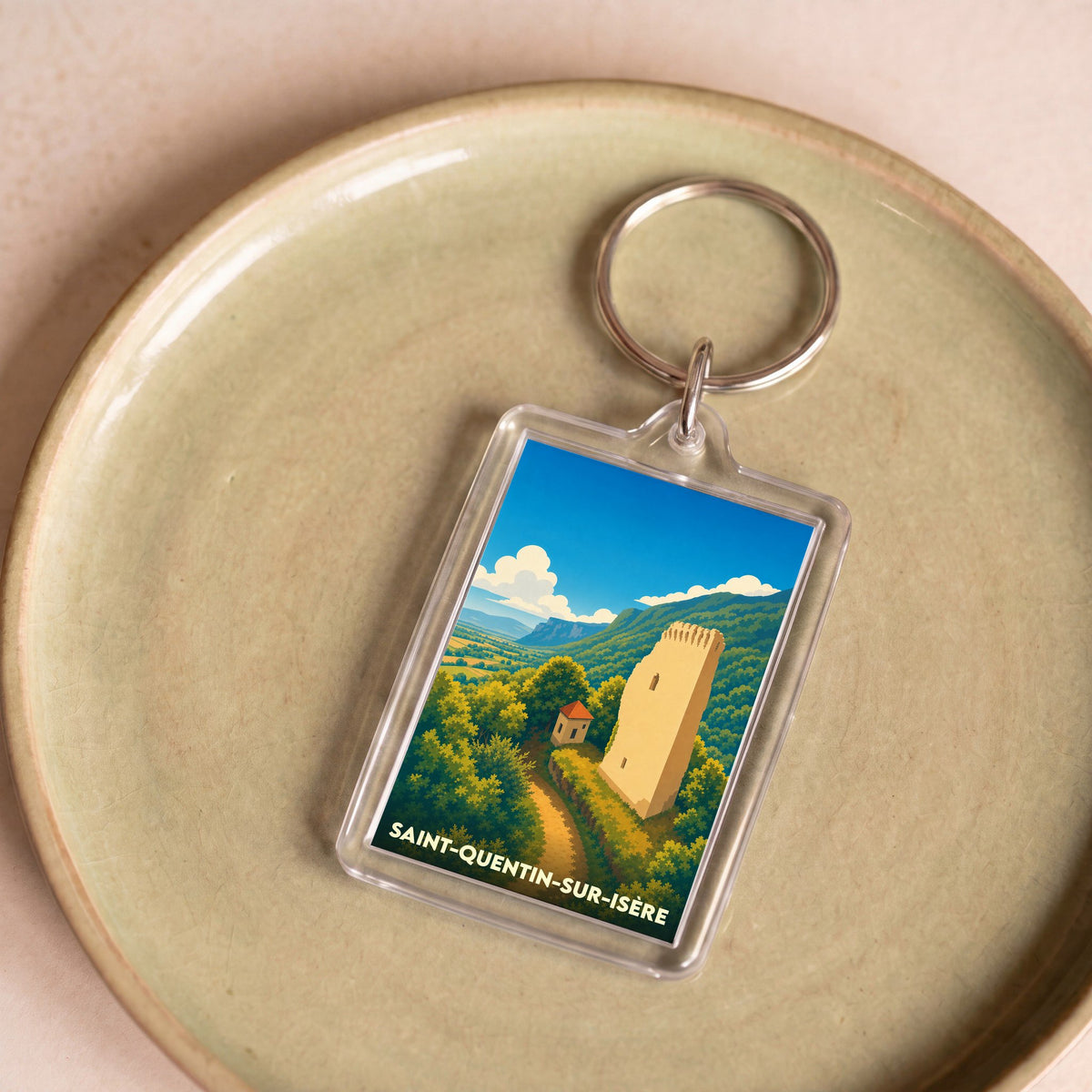 Porte-clés souvenir de la ville de Saint-Quentin-sur-Isère avec une illustration stylisée.