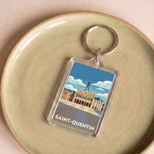 Porte-clés souvenir de la ville de Saint-Quentin avec une illustration stylisée.