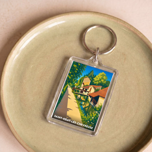 Porte-clés souvenir de la ville de Saint-Rémy-lès-Chevreuse avec une illustration stylisée.