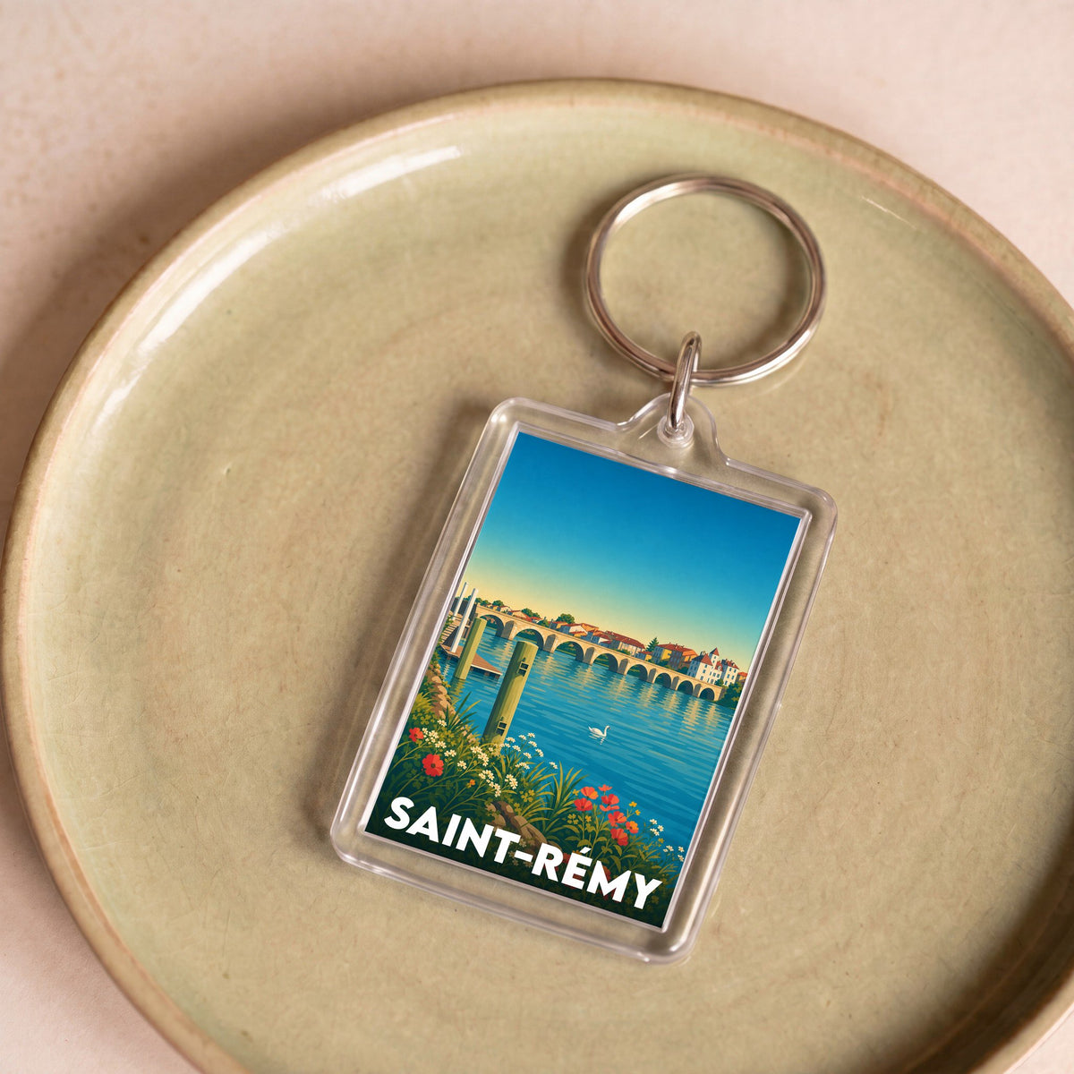 Porte-clés souvenir de la ville de Saint-Rémy avec une illustration stylisée.