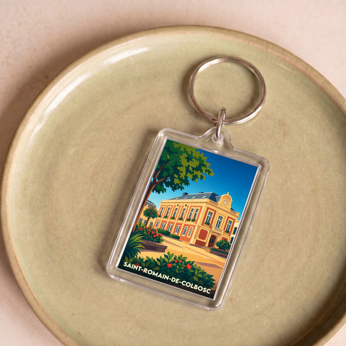 Porte-clés souvenir de la ville de Saint-Romain-de-Colbosc avec une illustration stylisée.