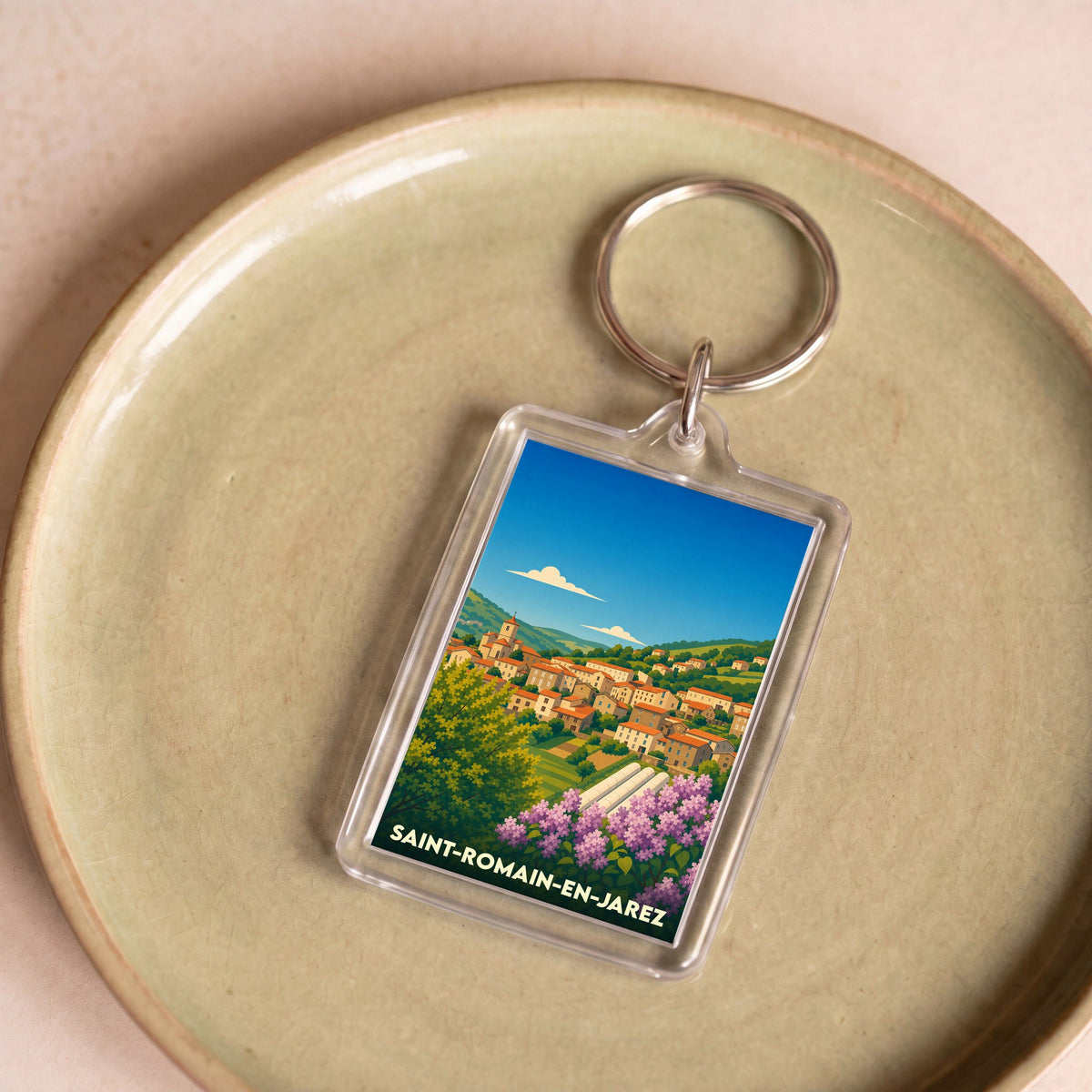 Porte-clés souvenir de la ville de Saint-Romain-en-Jarez avec une illustration stylisée.