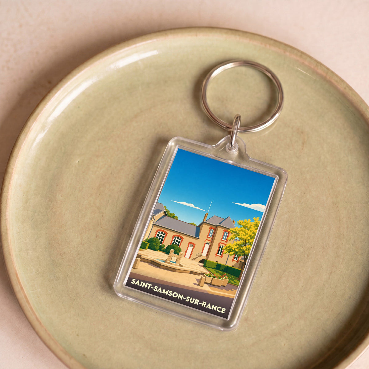 Porte-clés souvenir de la ville de Saint-Samson-sur-Rance avec une illustration stylisée.