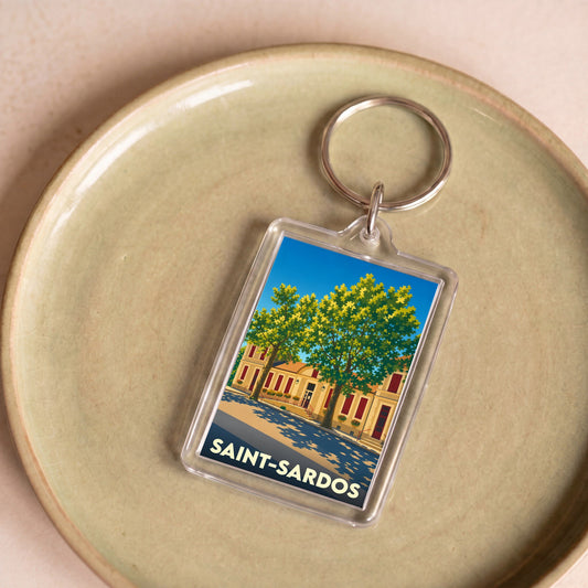 Porte-clés souvenir de la ville de Saint-Sardos avec une illustration stylisée.