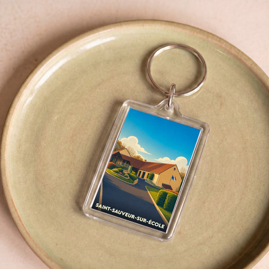Porte-clés souvenir de la ville de Saint-Sauveur-sur-École avec une illustration stylisée.