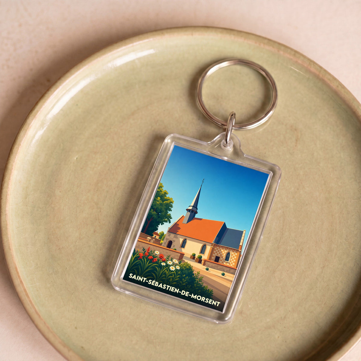 Porte-clés souvenir de la ville de Saint-Sébastien-de-Morsent avec une illustration stylisée de son église.