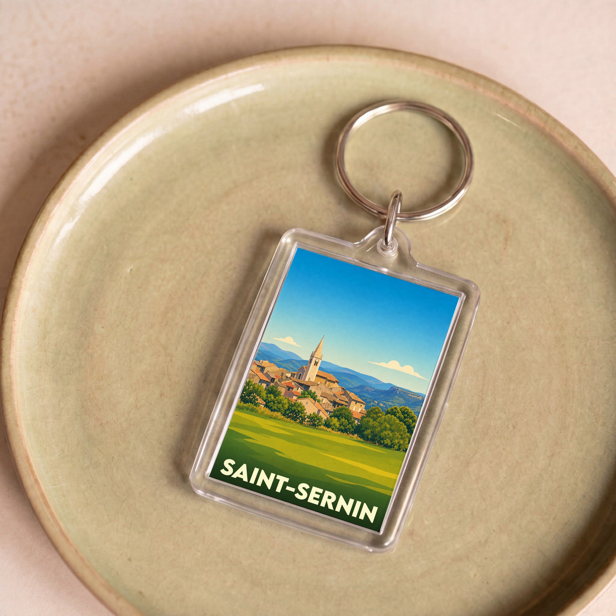 Porte-clés souvenir de la ville de Saint-Sernin avec une illustration stylisée.