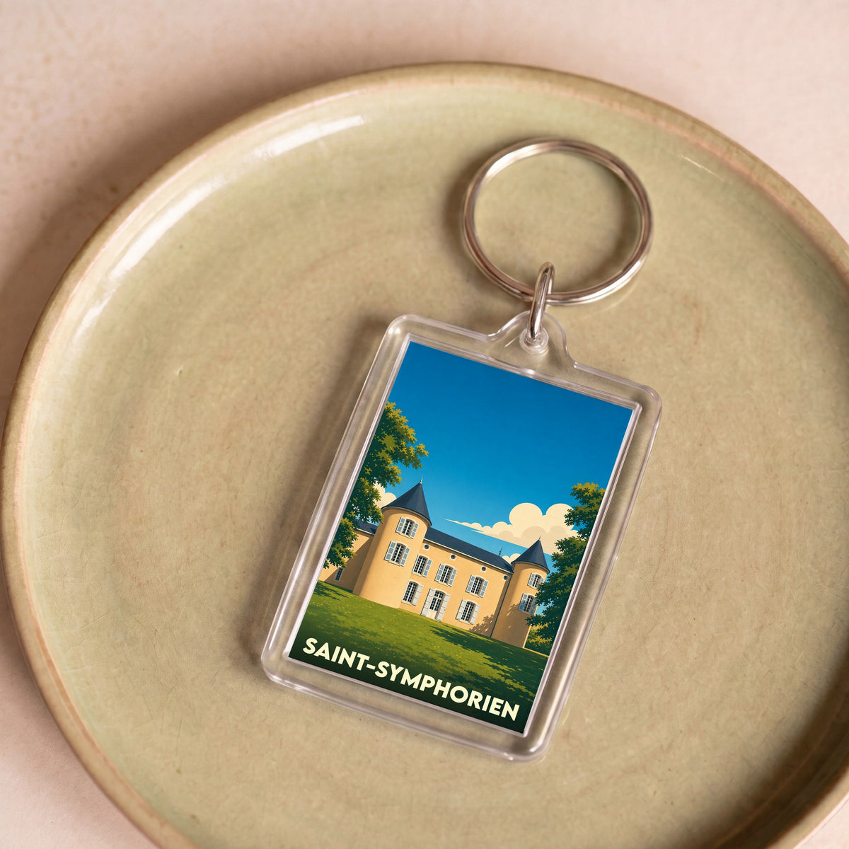 Porte-clés souvenir de la ville de Saint-Symphorien avec une illustration stylisée d'un château.