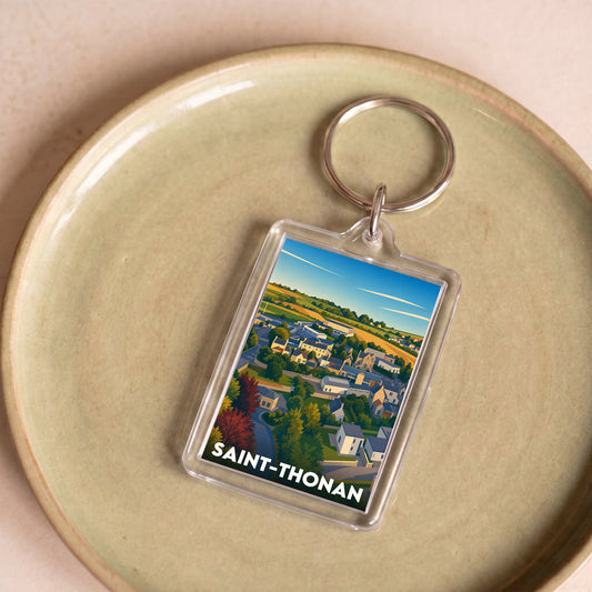 Porte-clés souvenir de la ville de Saint-Thonan avec une illustration stylisée.