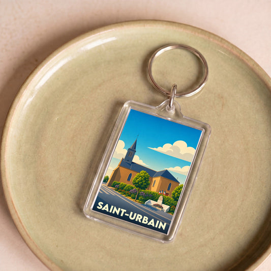 Porte-clés souvenir de la ville de Saint-Urbain avec une illustration stylisée de son église sous un ciel bleu.