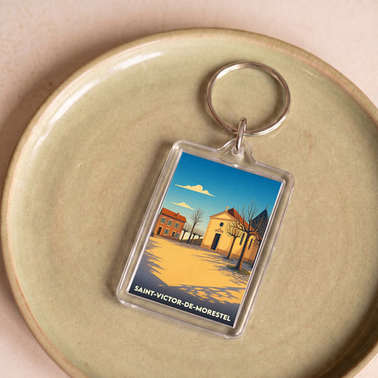 Porte-clés souvenir de la ville de Saint-Victor-de-Morestel avec une illustration stylisée.