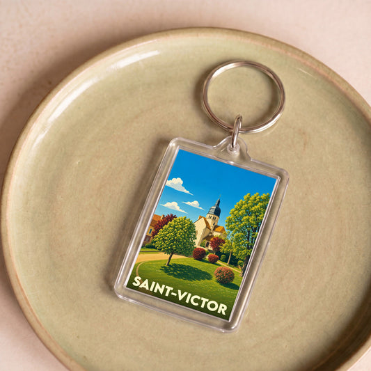 Porte-clés souvenir de la ville de Saint-Victor avec une illustration stylisée.