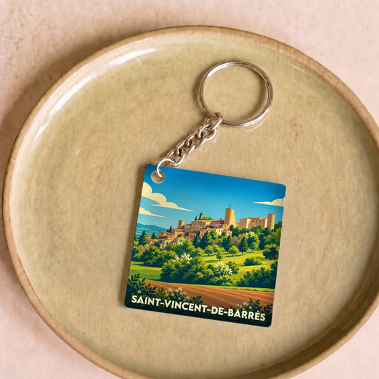 Porte-clés souvenir de la ville de Saint-Vincent-de-Barrès avec une illustration stylisée d'un village médiéval perché.