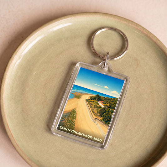 Porte-clés souvenir de la ville de Saint-Vincent-sur-Jard avec une illustration stylisée de sa côte.