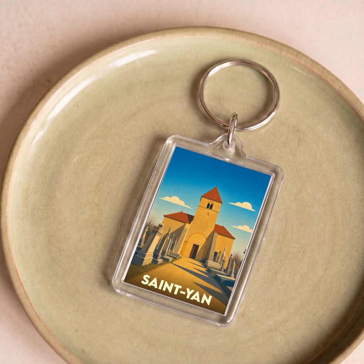 Porte-clés souvenir de la ville de Saint-Yan avec une illustration stylisée de son église.