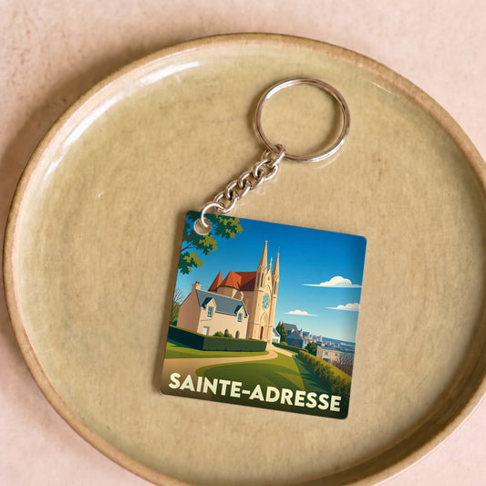 Porte-clés souvenir de la ville de Sainte-Adresse avec une illustration stylisée d'une église sous un ciel bleu.