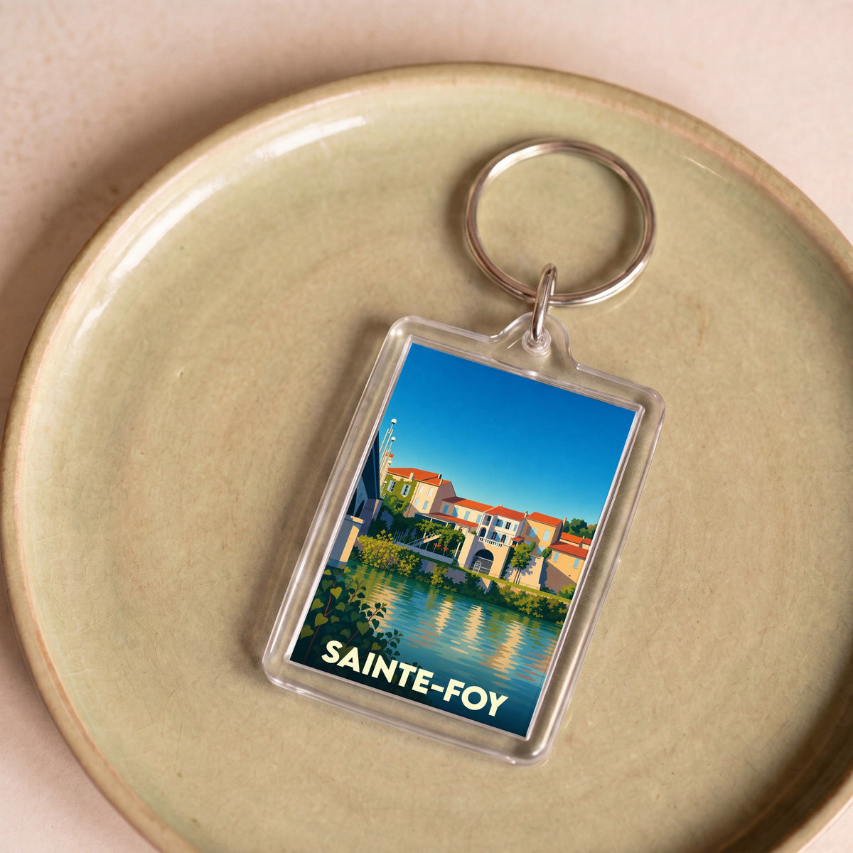 Porte-clés souvenir de la ville de Sainte-Foy avec une illustration stylisée.