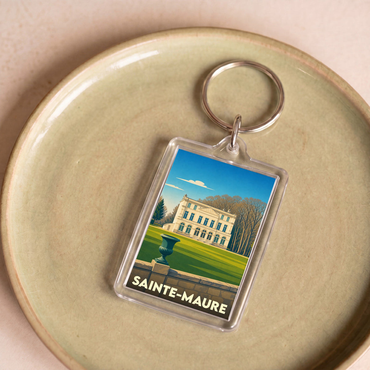 Porte-clés souvenir de la ville de Sainte-Maure avec une illustration stylisée d'un château.