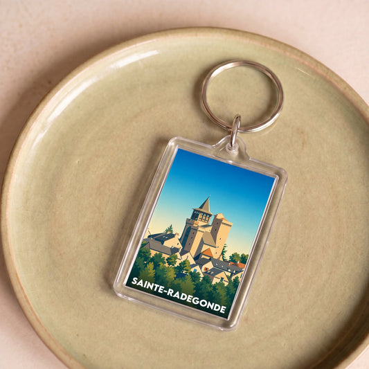 Porte-clés souvenir de la ville de Sainte-Radegonde avec une illustration stylisée.