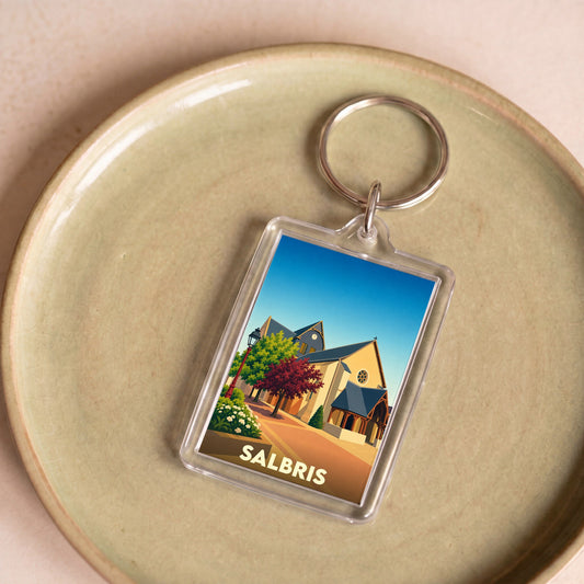 Porte-clés souvenir de la ville de Salbris avec une illustration stylisée d'une église et d'un paysage urbain.