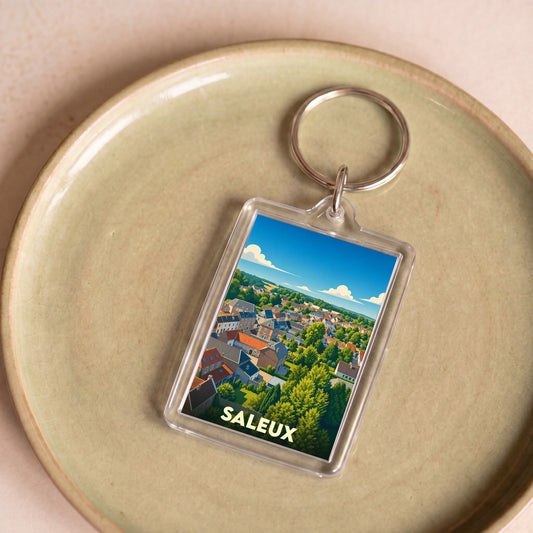 Porte-clés souvenir de la ville de Saleux avec une illustration stylisée d'un paysage urbain verdoyant.