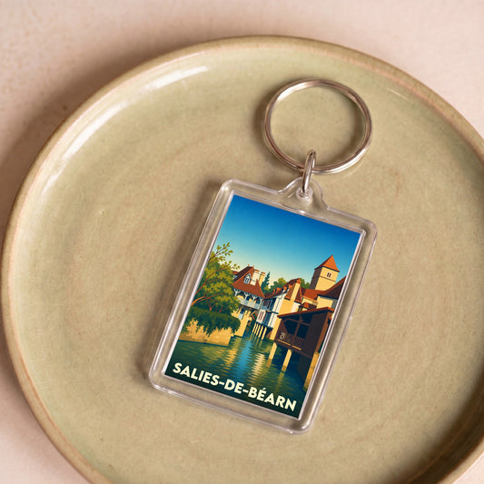 Porte-clés souvenir de la ville de Salies-de-Béarn avec une illustration stylisée.