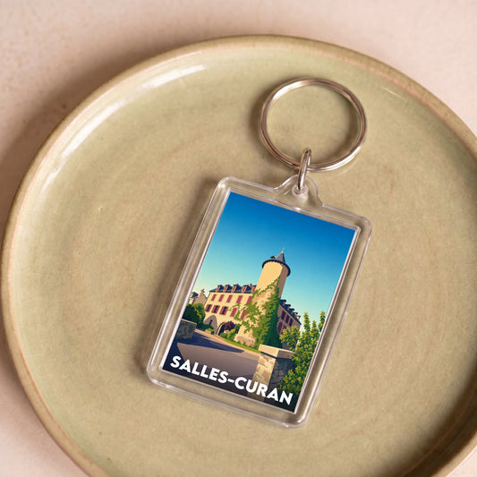 Porte-clés souvenir de la ville de Salles-Curan avec une illustration stylisée.