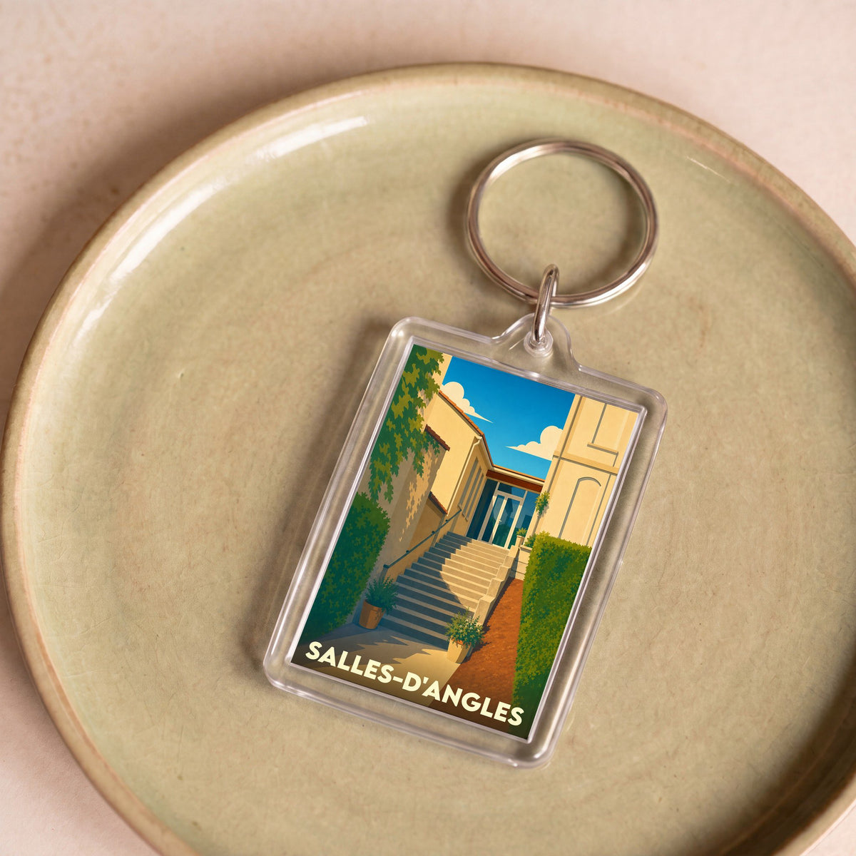 Porte-clés souvenir de la ville de Salles-d'Angles avec une illustration stylisée.