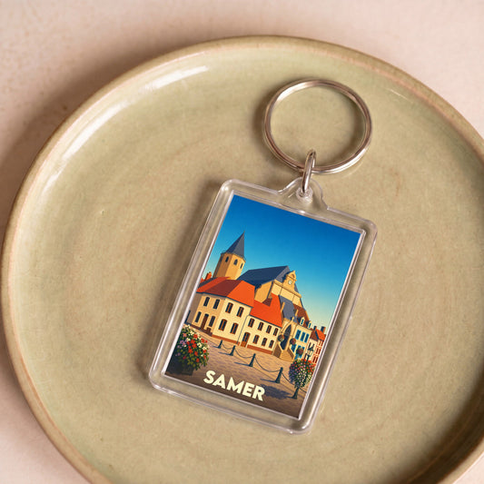Porte-clés souvenir de la ville de Samer avec une illustration stylisée de son architecture.