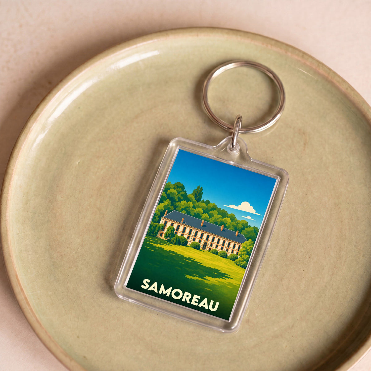 Porte-clés souvenir de la ville de Samoreau avec une illustration stylisée d'un château.