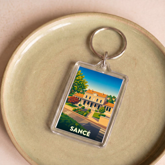 Porte-clés souvenir de la ville de Sancé avec une illustration stylisée.