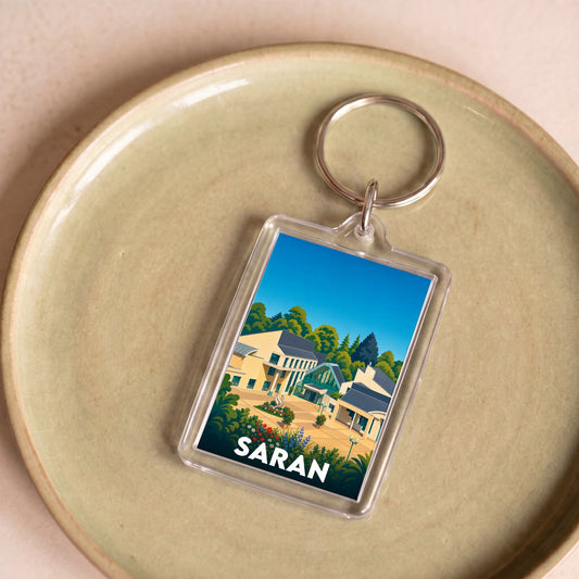 Porte-clés souvenir de la ville de Saran avec une illustration stylisée.