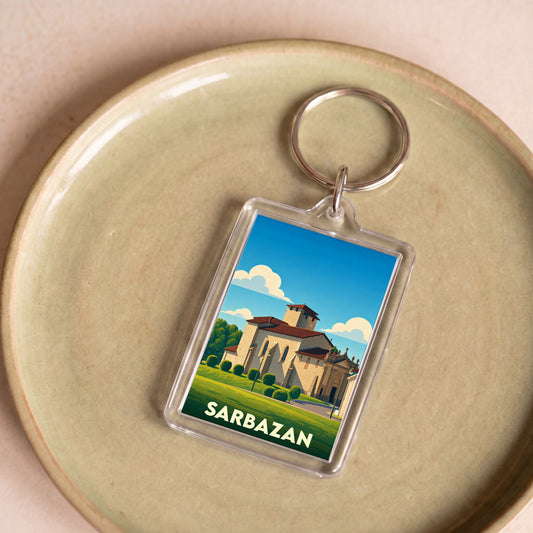 Porte-clés souvenir de la ville de Sarbazan avec une illustration stylisée de son église.