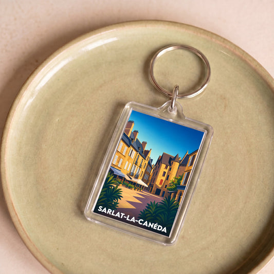 Porte-clés souvenir de Sarlat-la-Canéda avec une illustration stylisée de ses ruelles médiévales.