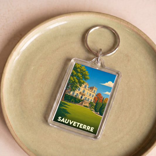 Porte-clés souvenir de la ville de Sauveterre avec une illustration stylisée.