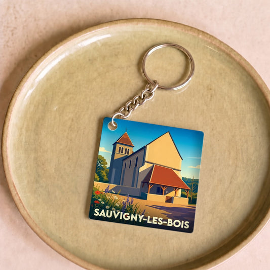 Porte-clés souvenir de la ville de Sauvigny-les-Bois avec une illustration stylisée de son église.