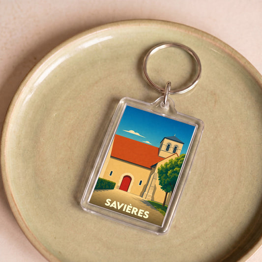 Porte-clés souvenir de la ville de Savières avec une illustration stylisée de son église.