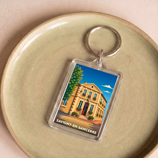 Porte-clés souvenir de la ville de Savigny-en-Sancerre avec une illustration stylisée.