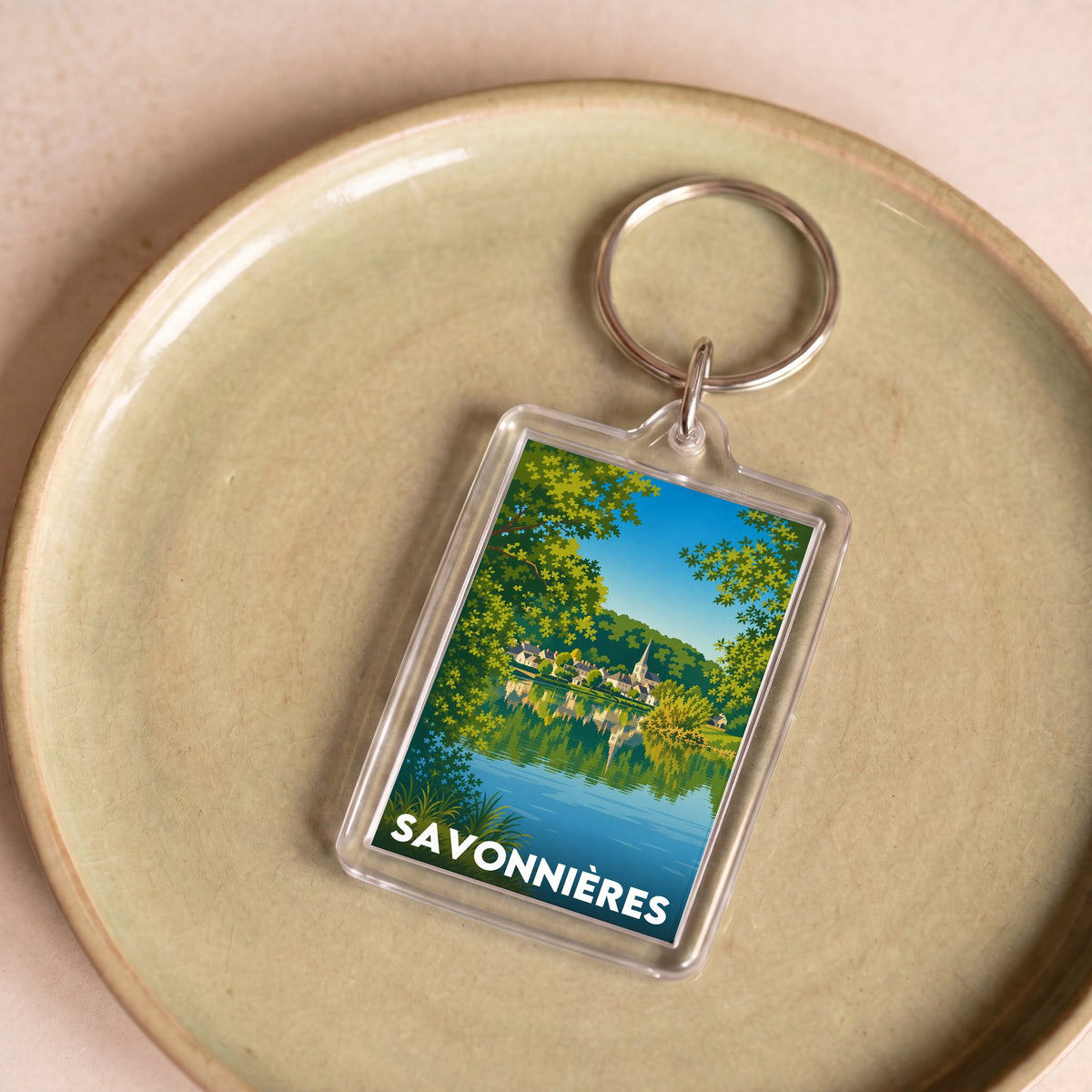 Porte-clés souvenir de la ville de Savonnières avec une illustration stylisée.