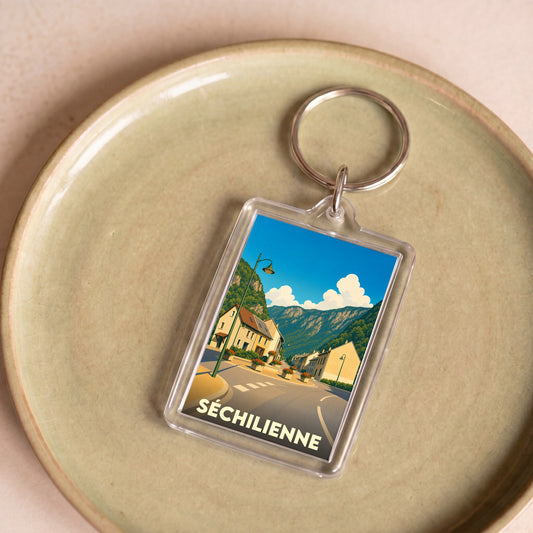 Porte-clés souvenir de la ville de Séchilienne avec une illustration stylisée.