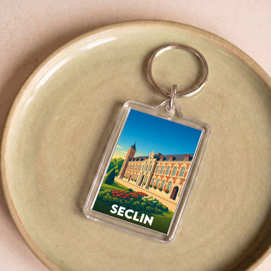 Porte-clés souvenir de la ville de Seclin avec une illustration stylisée d'un monument local.