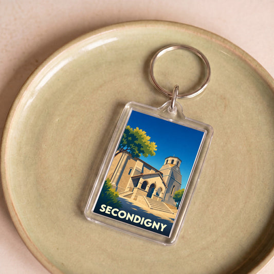 Porte-clés souvenir de la ville de Secondigny avec une illustration stylisée de son église.