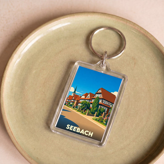 Porte-clés souvenir de la ville de Seebach avec une illustration stylisée de maisons à colombages.