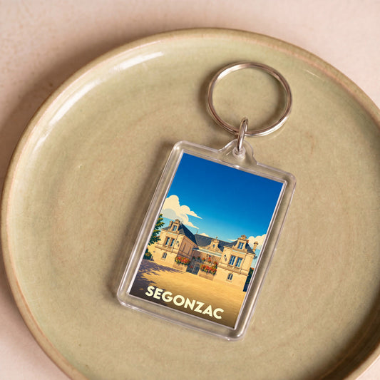 Porte-clés souvenir de la ville de Segonzac avec une illustration stylisée de son hôtel de ville.